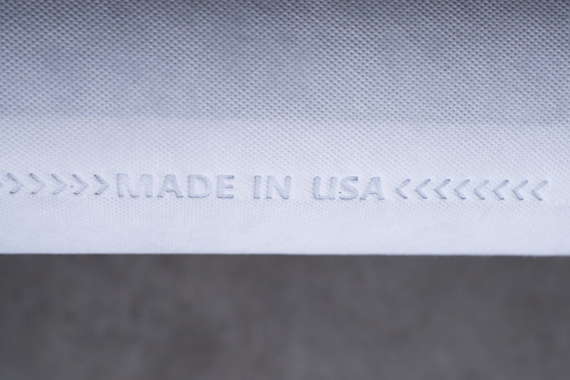 Close-up of white textured material with 'Made in USA' embossed, product manufacturing detail